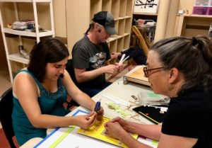 Danielle using a hot glue gun for the 1st time - with Ann Cunningham and Brad using the paper cutter