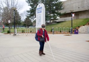 Mikayla walking in front of the ACC Main Building