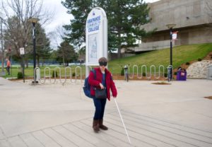 Mikayla walking in front of the ACC Main Building