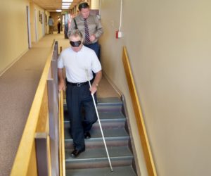 Scott going down the stairs for the 1st time with a cane and wearing sleepshades
