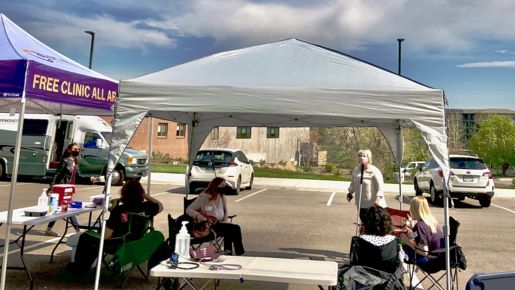 Two women in the 15 minute waiting tent on vaccination day