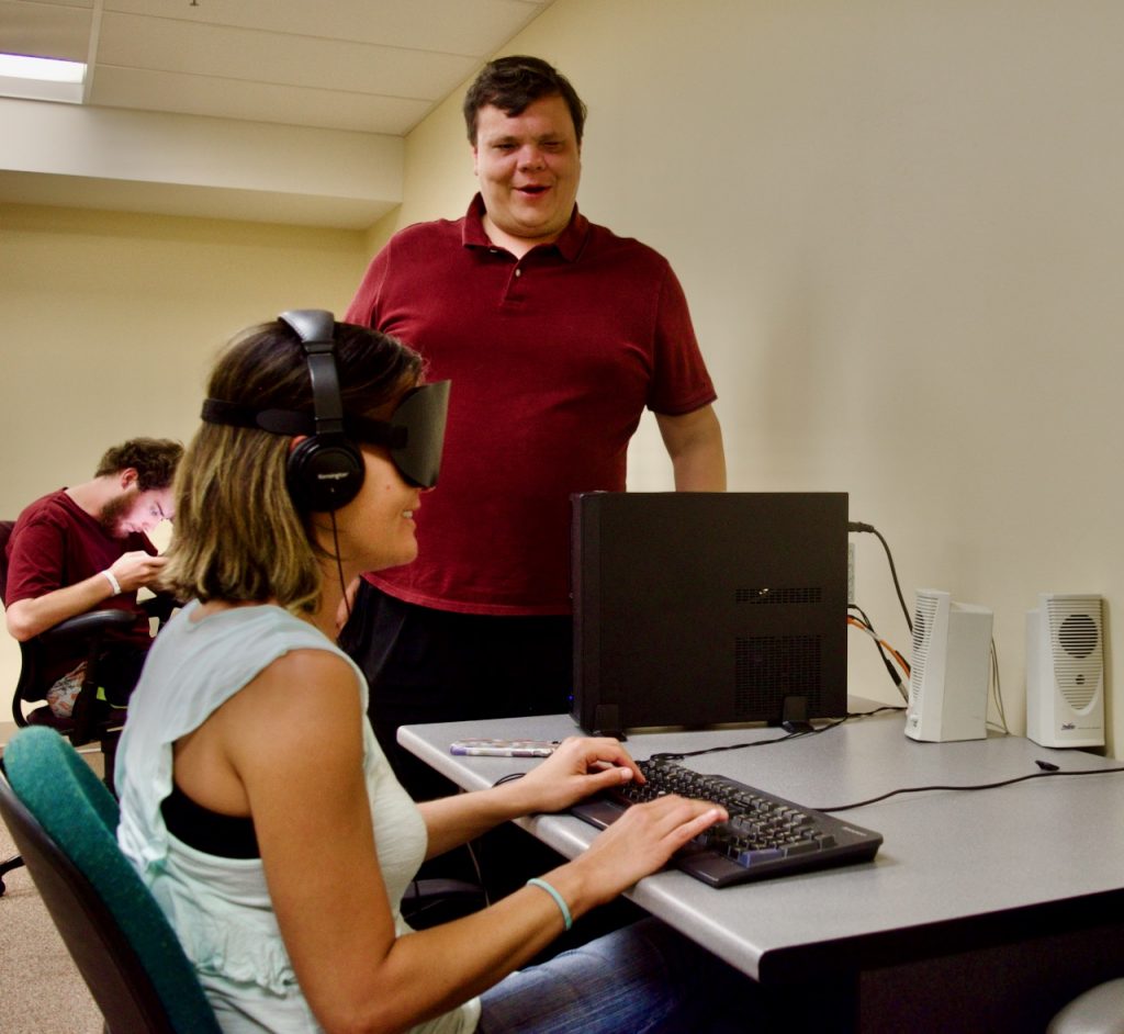 Amanda W. working on the computer with Tech Instructor Brett Boyer