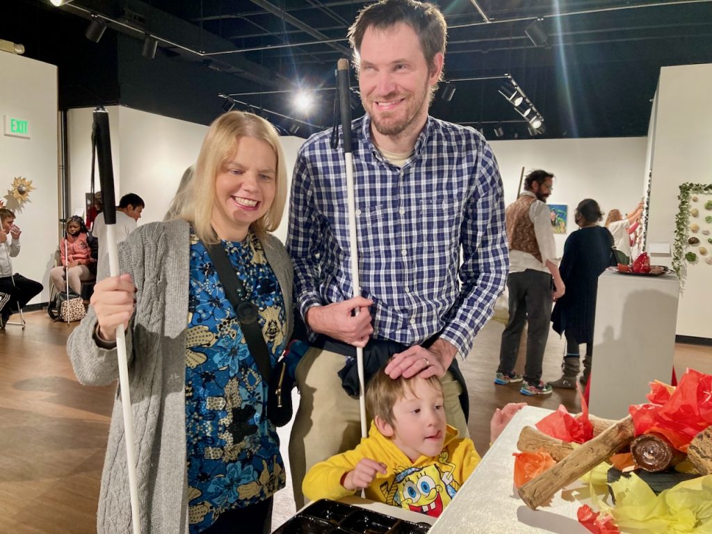 Maureen, David, and Logan Looking at Artwork at at Shared Visions ACC-CCB Tactile Art Show 11-2022