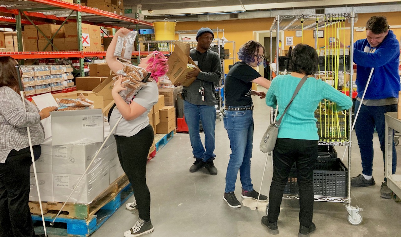 People carry boxes in a warehouse