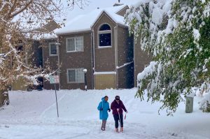 Ernesto and Megan smiling, snow falling