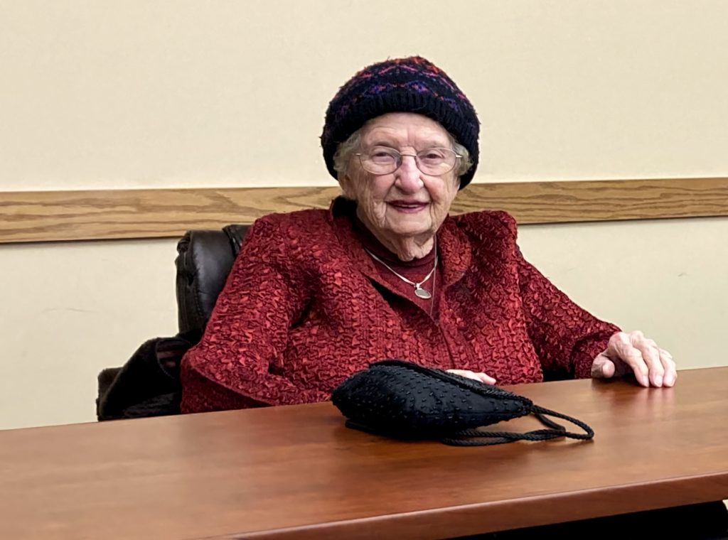 An Older Blind Woman smiling warmly.