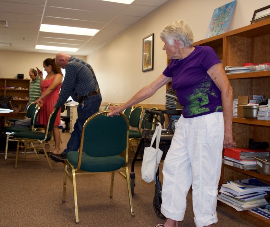 A young woman in line with three seniors exercising