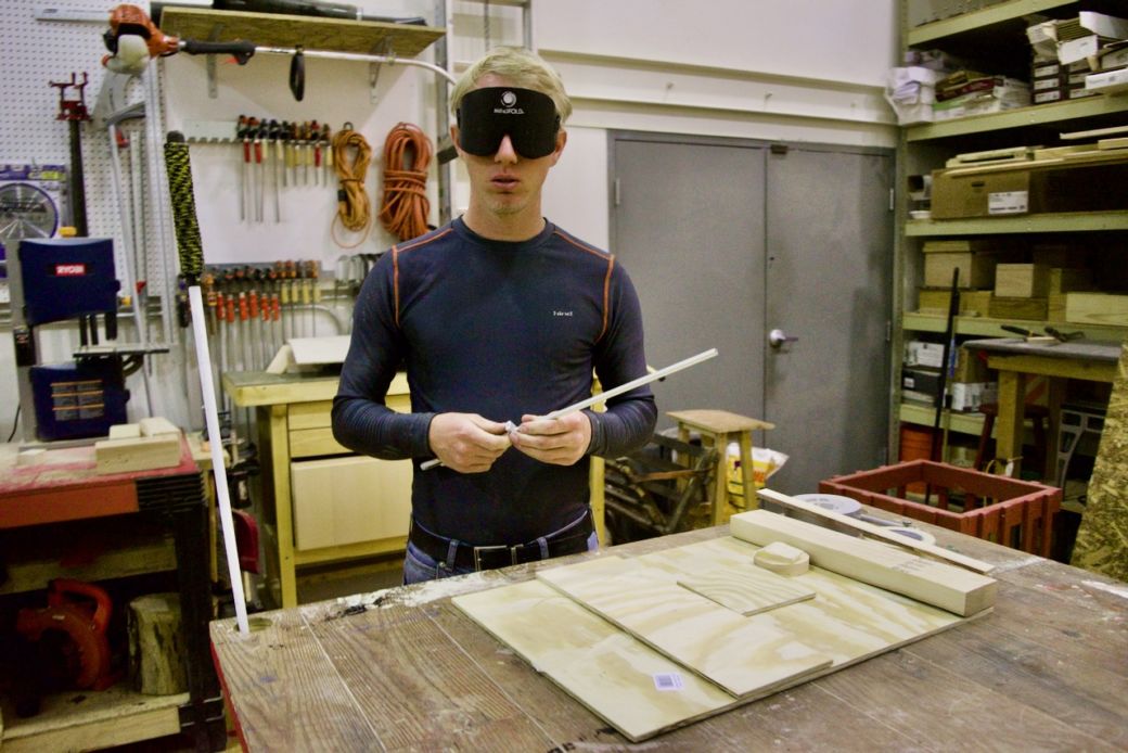 Trevor uses a Click Rule to measure out pieces for a model of a Light Rail Station he is building in Wood Shop