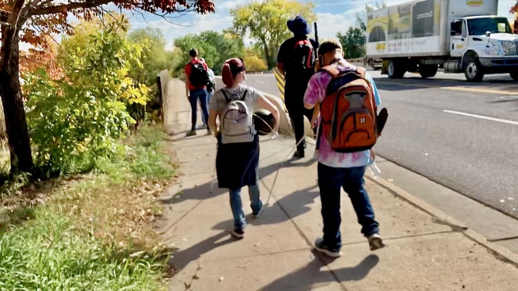 CCB folks Matthew, Skysha Abdi and Cameron walk along Bowles ave about to cross the bridge over the South Platte River
